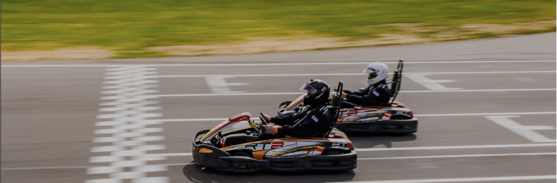 Two go-karts racing on a professional circuit