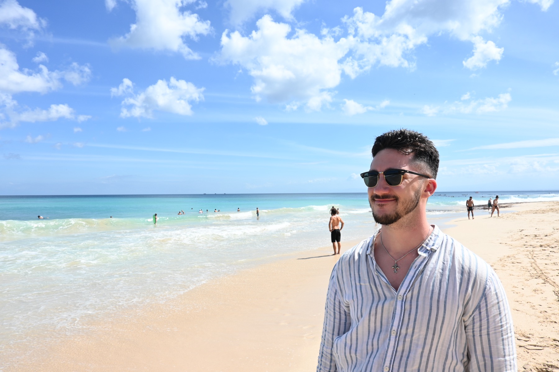 Miljan on a beach, looking pleased with himself